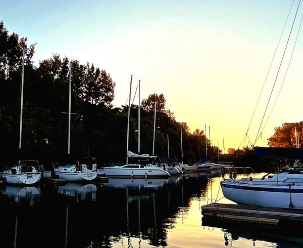 Sailboats docked at Hidden Harbor marina at sunrise