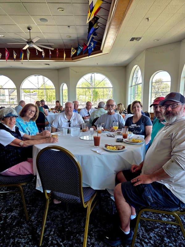 Yacht club members sitting around a table at Pittsburg Yacht Club during breakfast
